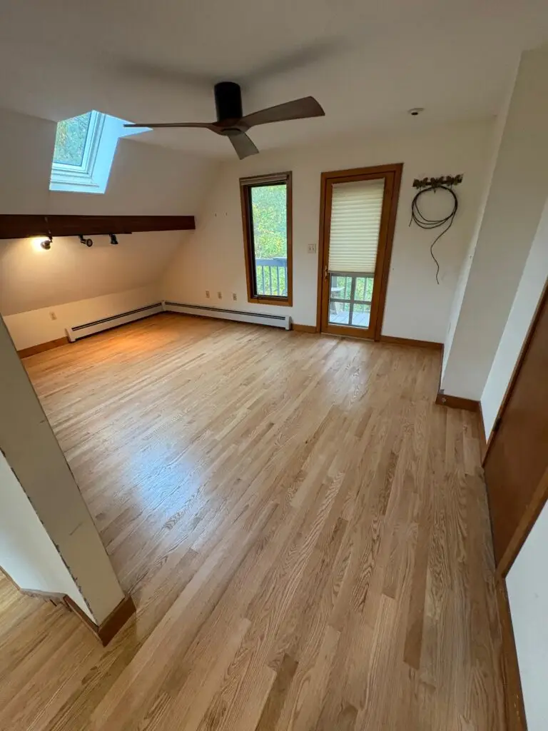 Empty room with wooden flooring.
