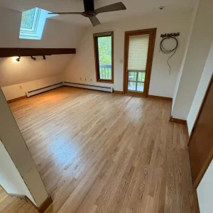 Empty room with wooden flooring.
