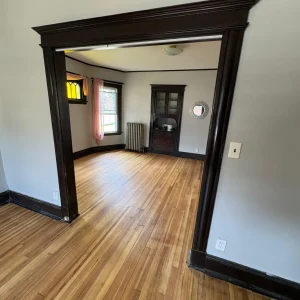 Empty room with wooden flooring.